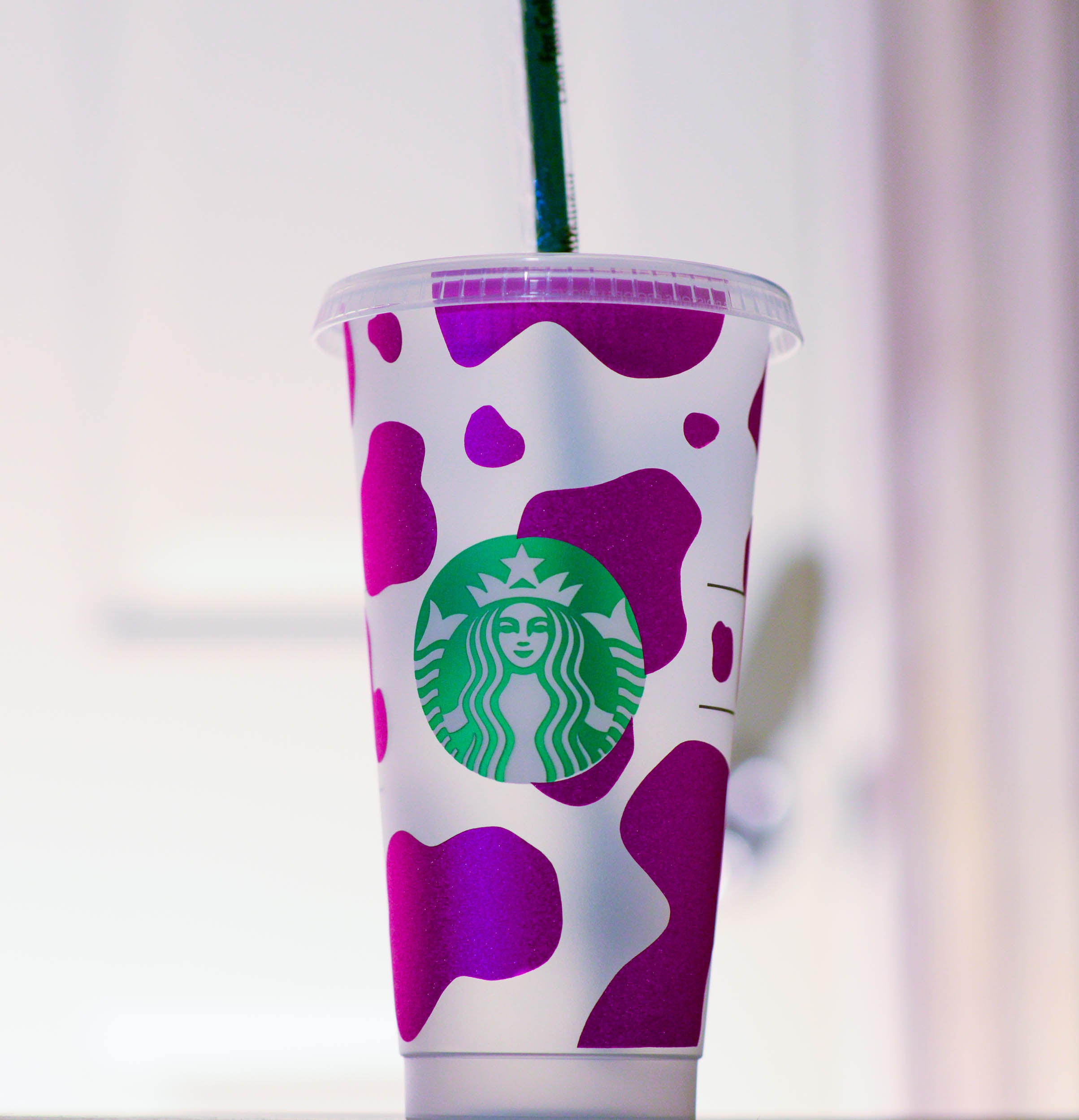 Starbucks cup with pink cow shimmer vinyl applied.