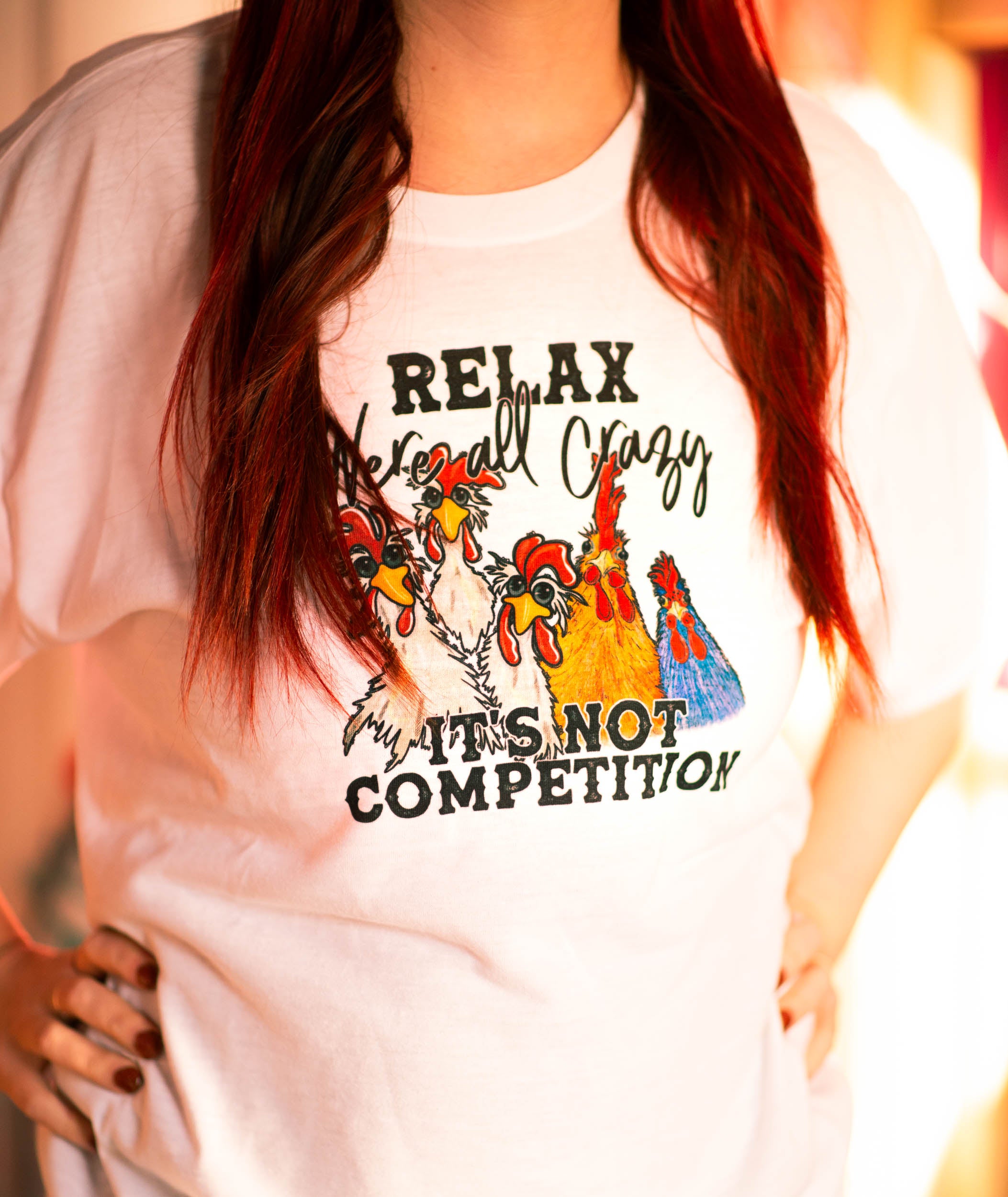 Relax, we're all crazy. Its not a competition. White t-shirt (Adult)